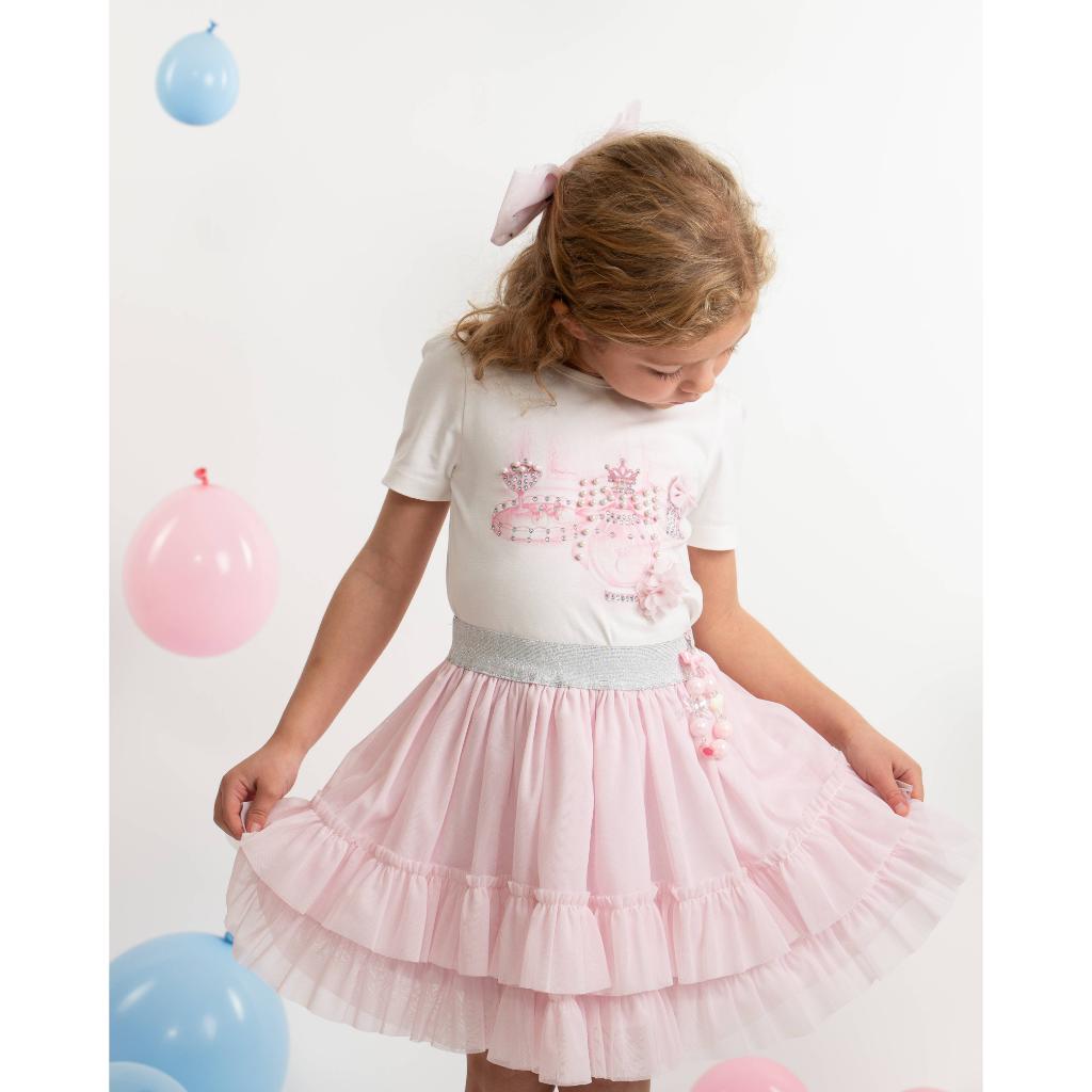 Model wearing a Caramelo pink perfume T‑shirt and layered skirt set for girls