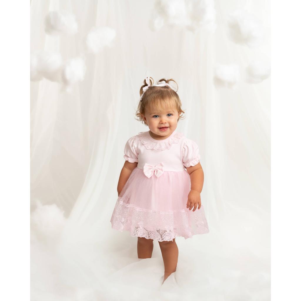 Caramelo pink lace baby dress with matching headband. Elegant tulle, bow and lace details make this the perfect outfit for birthdays, christenings and special occasions.