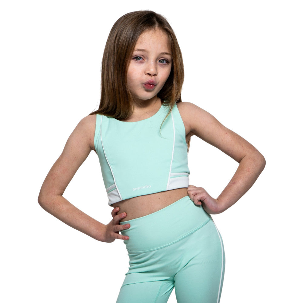 Young girl wearing a mint green Ansandro athletic outfit on a white background