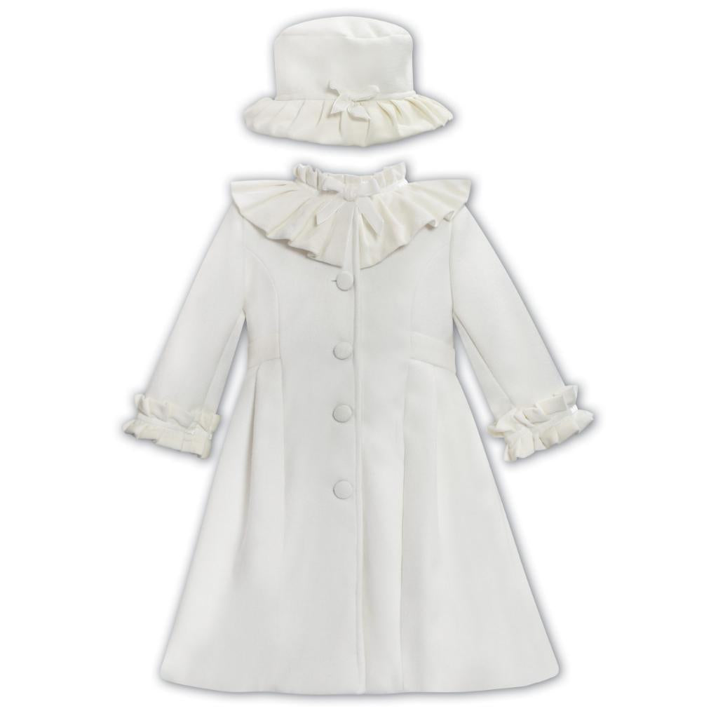 An ivory velvet girls' coat with a ruffle collar and cuffs, and a matching hat with a ruffle trim.
