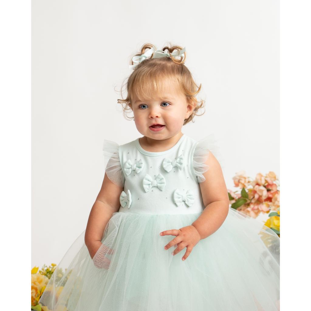 Caramelo mint tulle dress with bow‑detail bodice and layered skirt. A soft, elegant occasion dress for baby girls