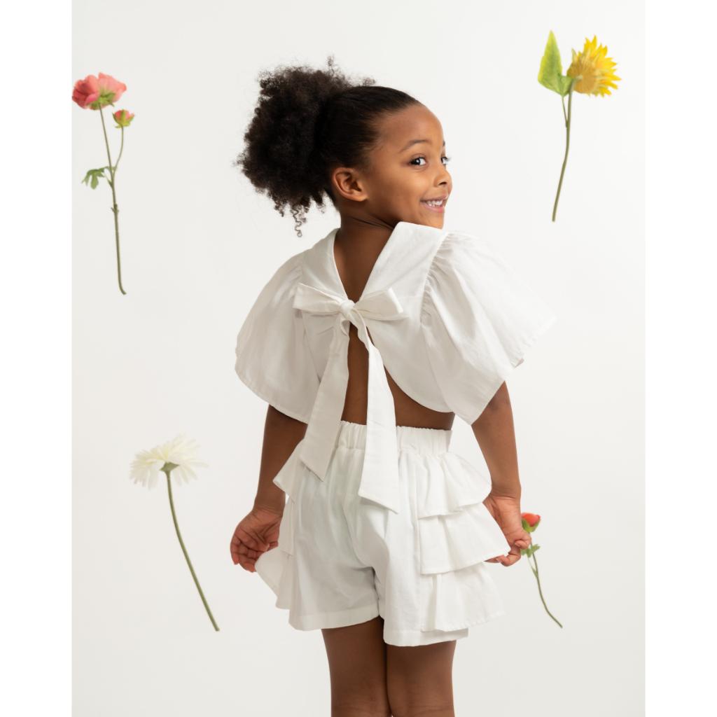 Caramelo white ruffle short set with statement back bow and matching layered‑ruffle shorts. A soft, elegant summer outfit for girls