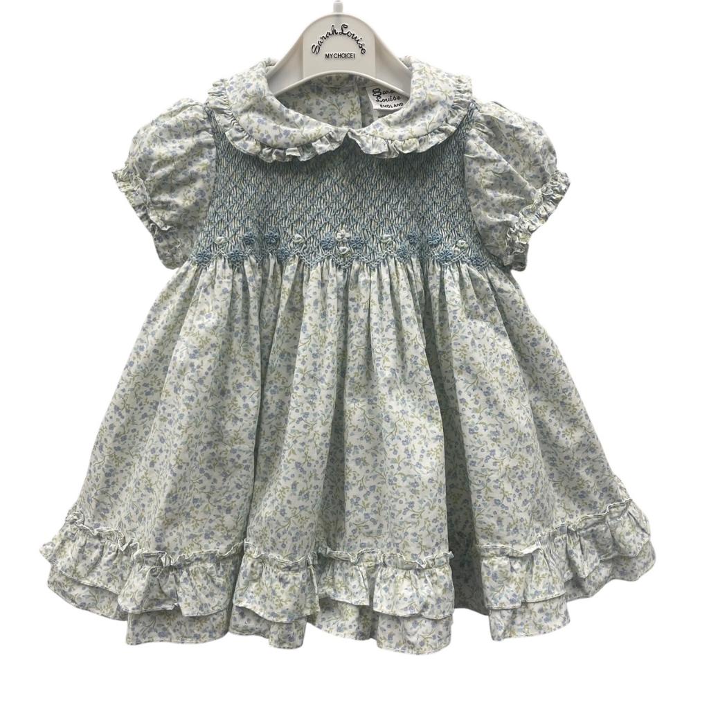 Floral dress on a hanger with a white background