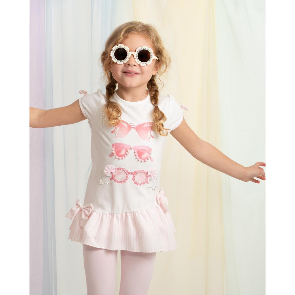 Model wearing a Caramelo pink legging set with bow‑detail top